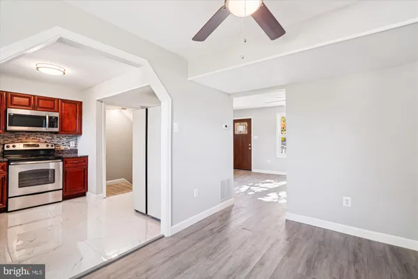 a view of kitchen with sink microwave and refrigerator