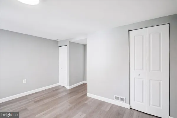a view of a room with wooden floor