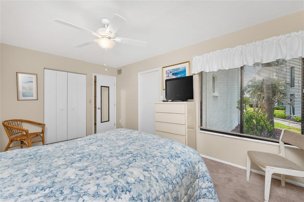 2955 North Beach Road, Unit B614 Englewood, FL 34223 - Photo 26 of 67 a bedroom with a bed and a television