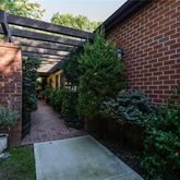 a view of backyard with plants and outdoor seating