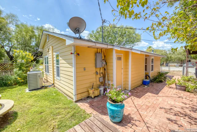 a backyard of a house with flower plants