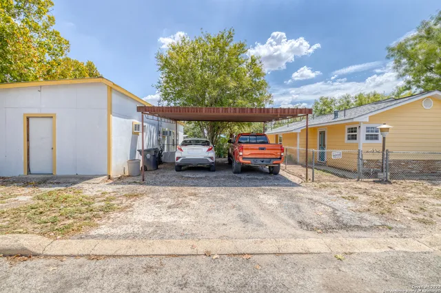 a view of a house with truck parked
