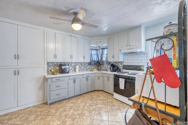 a kitchen with stainless steel appliances granite countertop a sink and cabinets