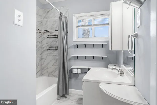 a bathroom with a sink a bathtub and a shower