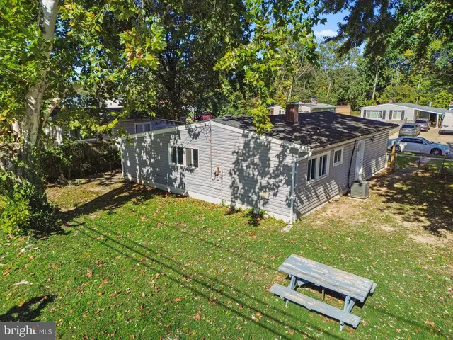 an aerial view of a house with a yard table and chairs