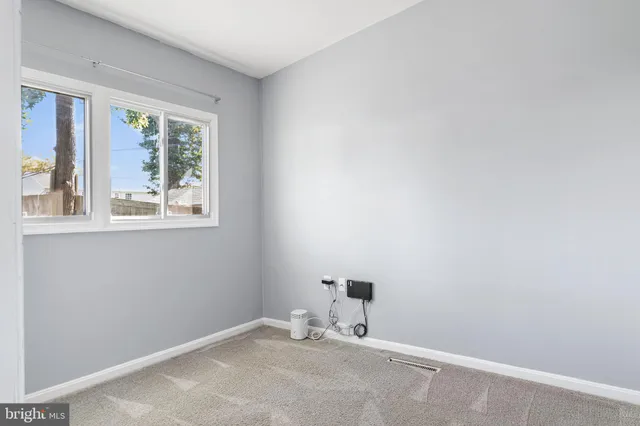 a room with a window and a ceiling fan