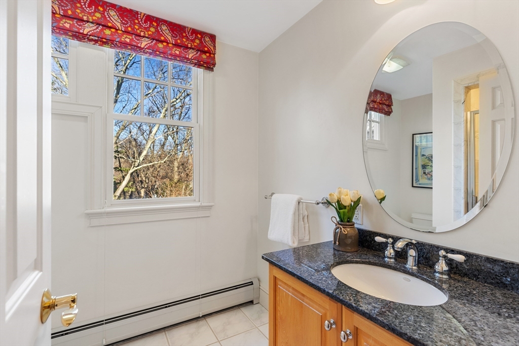 22 Fairbanks Road Lexington, MA 02421 - Photo 36 of 41 a bathroom with a granite countertop sink and a mirror