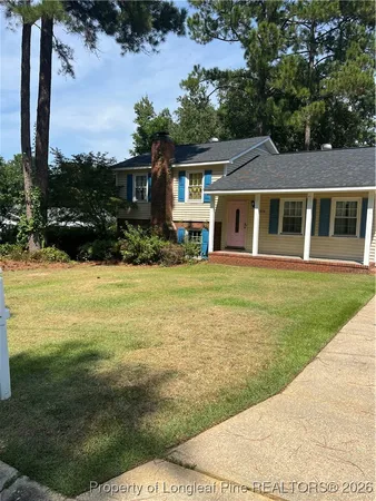 a view of a house with a yard