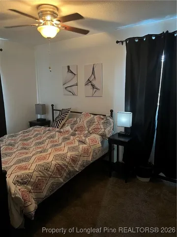 a bedroom with a bed and a mirror