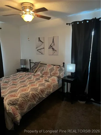 a bedroom with a bed and a mirror