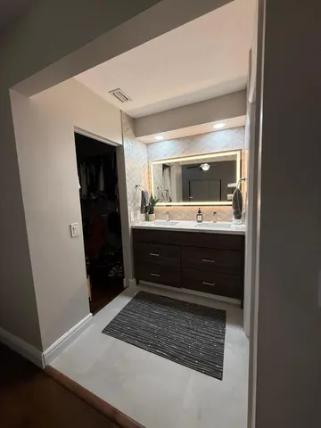 a bathroom with a sink a mirror and a shower