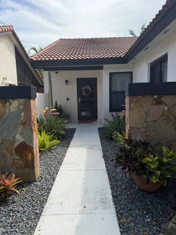 a front view of a house with garden