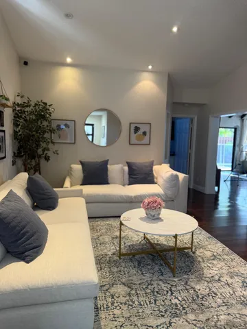 a living room with furniture and wooden floor