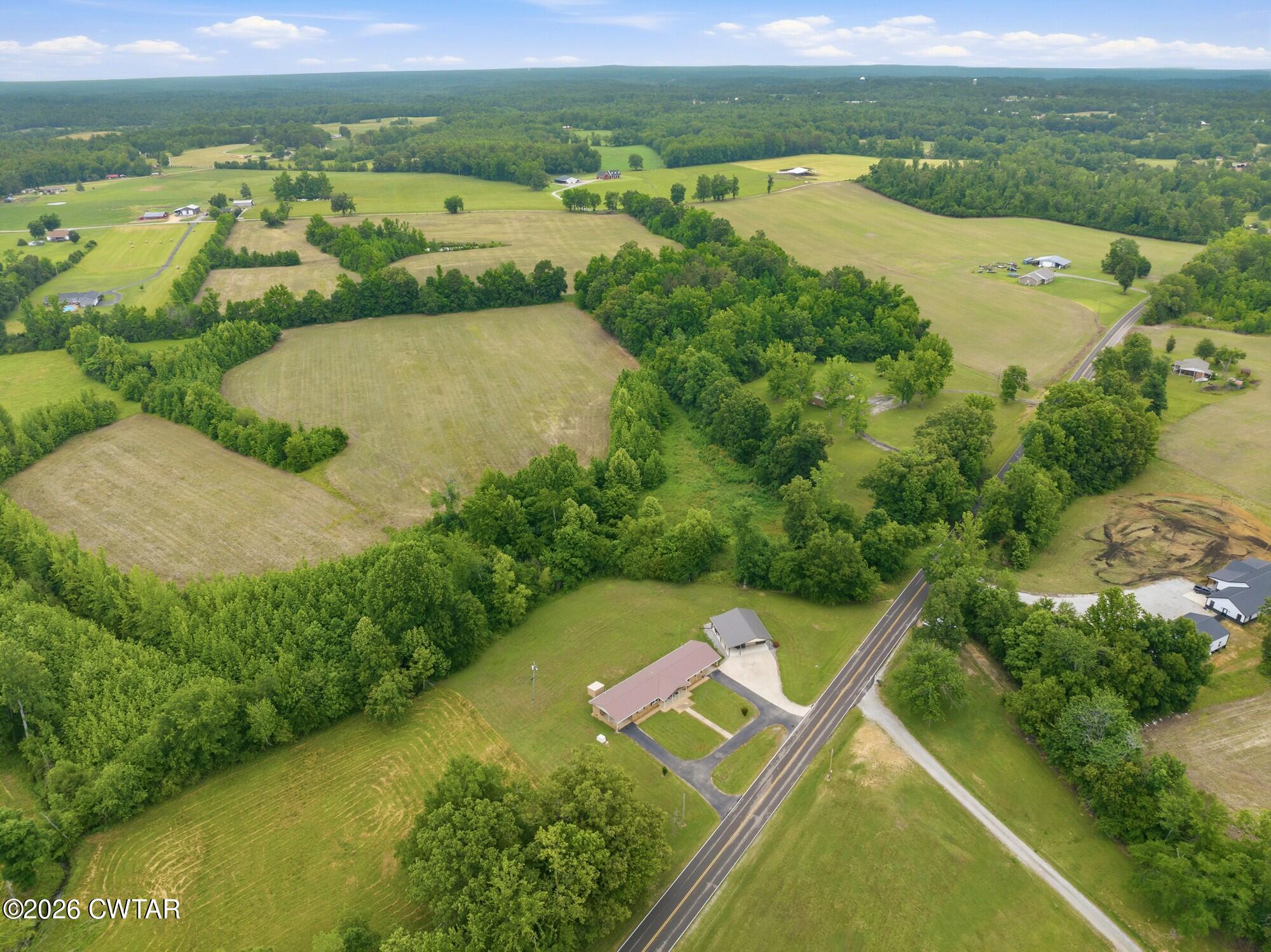 an aerial view of residential houses with outdoor space and river