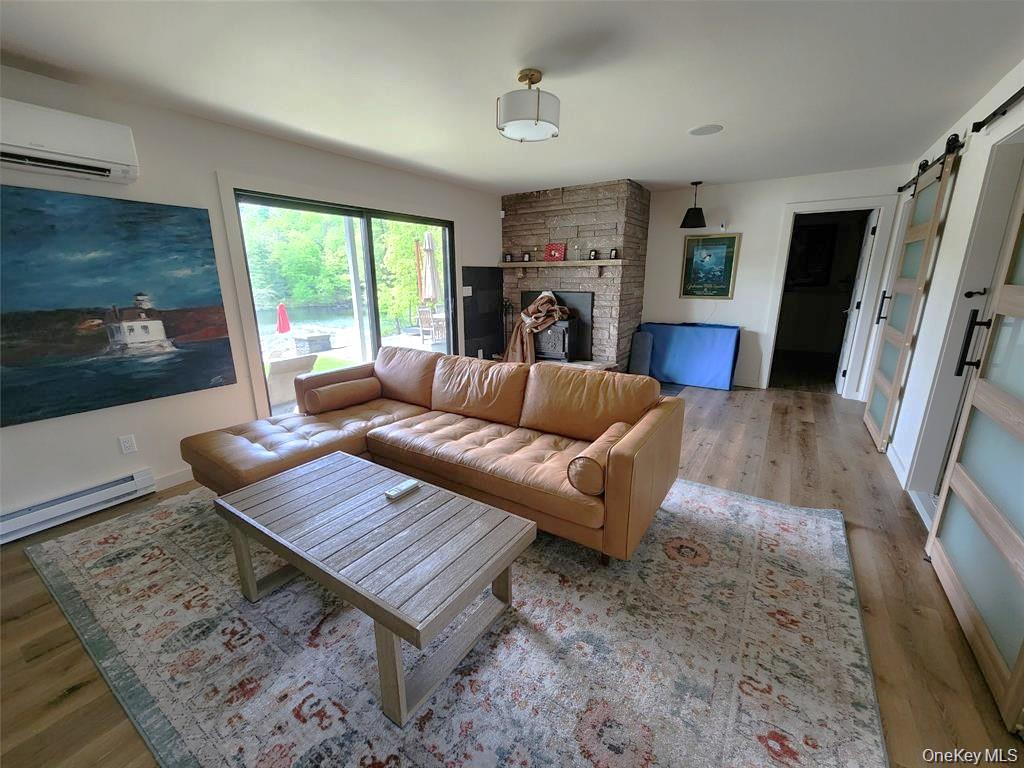 53 Lake Pleasant Road Staatsburg, NY 12580 - Photo 25 of 34 a living room with furniture fireplace and a flat screen tv