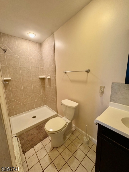 5327 Berkshire Valley Road, Unit 5 Oak Ridge, NJ 07438 - Photo 15 of 32 a bathroom with a sink a toilet and shower