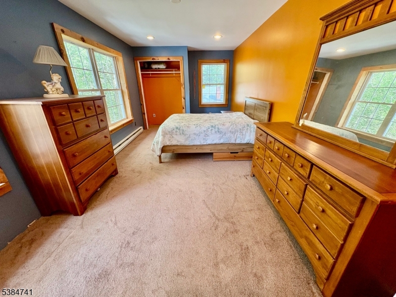 5327 Berkshire Valley Road, Unit 5 Oak Ridge, NJ 07438 - Photo 16 of 32 a bedroom with a bed and wooden floor