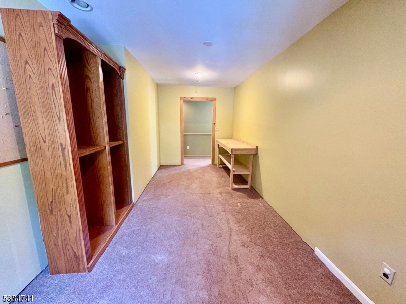 5327 Berkshire Valley Road, Unit 5 Oak Ridge, NJ 07438 - Photo 17 of 32 a view of a hallway with wooden floor and furniture