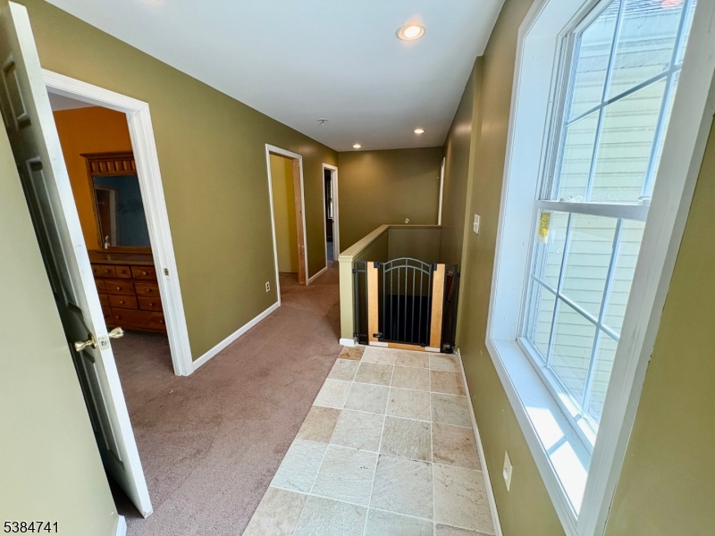 5327 Berkshire Valley Road, Unit 5 Oak Ridge, NJ 07438 - Photo 20 of 32 a view of a hallway with furniture