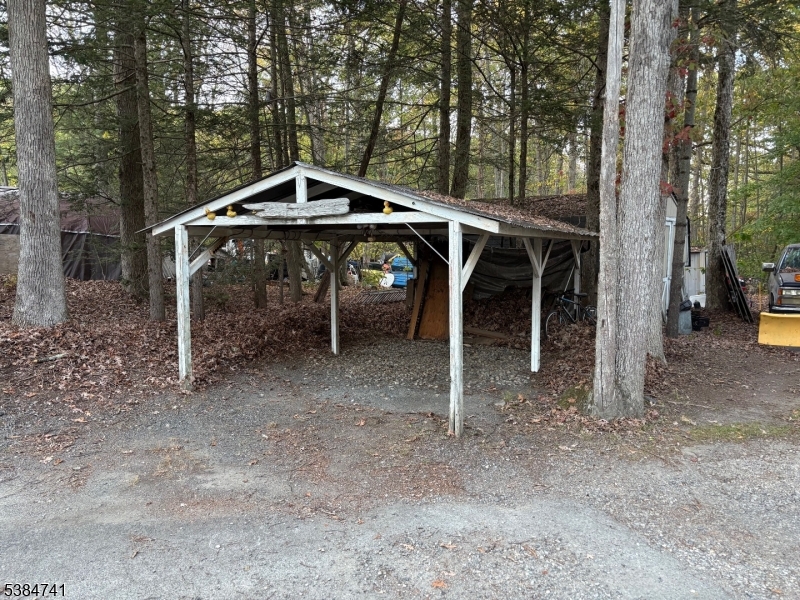 5327 Berkshire Valley Road, Unit 5 Oak Ridge, NJ 07438 - Photo 25 of 32 a wooden house with trees in the background