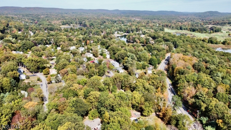 5327 Berkshire Valley Road, Unit 5 Oak Ridge, NJ 07438 - Photo 32 of 32 an aerial view of a houses with a lush green hillside