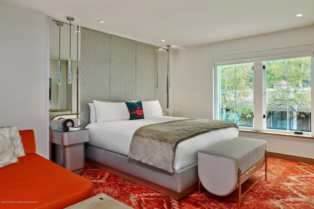 a bedroom with a bed and a large window