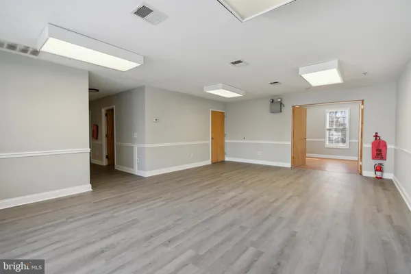 an empty room with wooden floor and closet