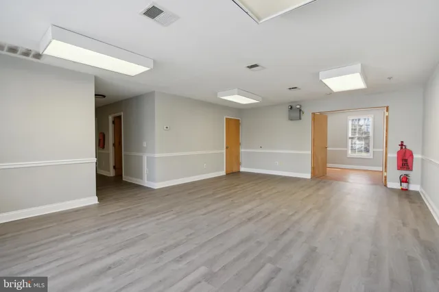 an empty room with wooden floor and closet