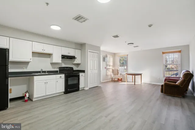 a view of room with furniture and wooden floor