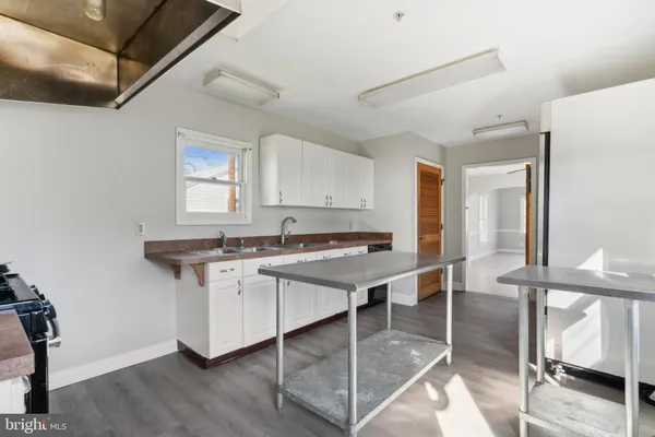 a kitchen with a sink cabinets and window