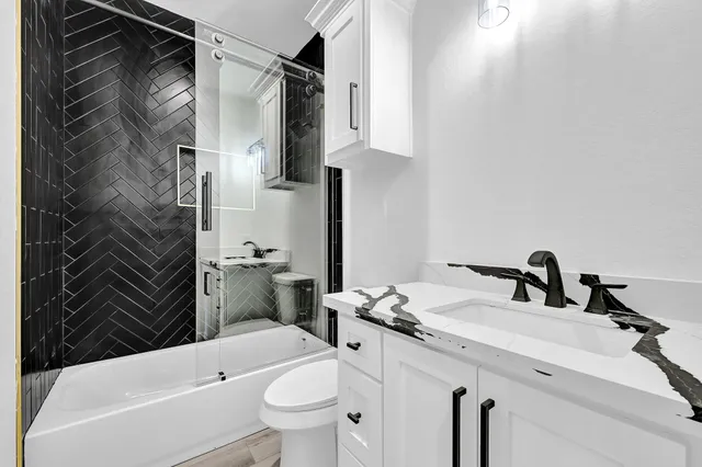 a view of washer and dryer with kitchen in the background