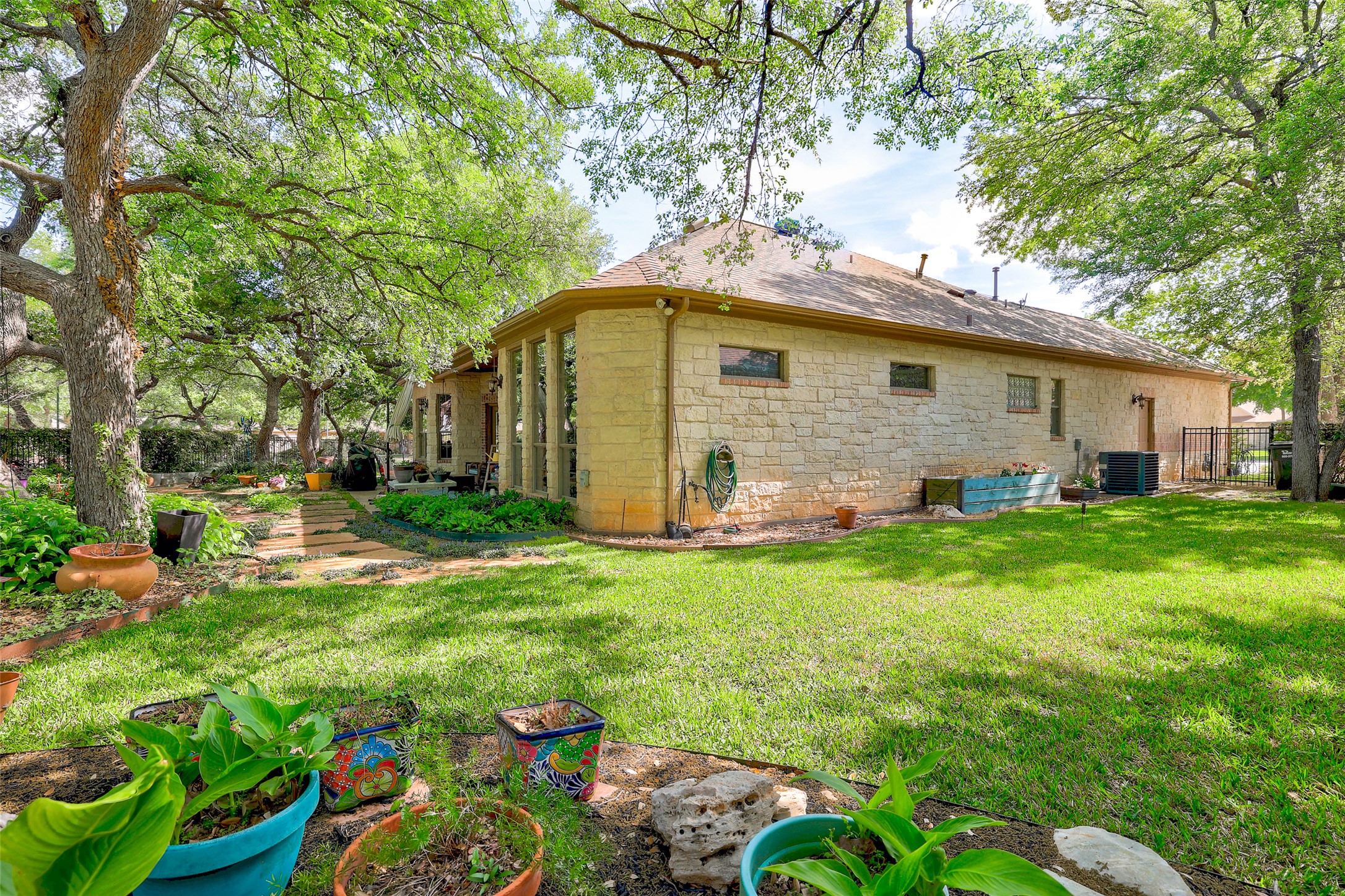 805 Boquilla Trail Georgetown, TX 78633 - Photo 35 of 40 a view of a backyard with plants and large trees