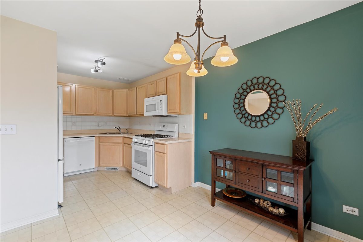 962 Willow Street Itasca, IL 60143 - Photo 12 of 33 a kitchen with cabinets and stainless steel appliances