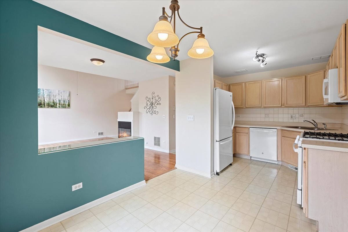 962 Willow Street Itasca, IL 60143 - Photo 15 of 33 a kitchen with a refrigerator and a stove top oven