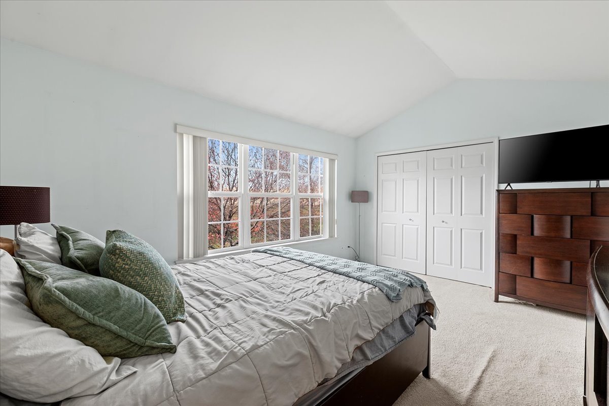 962 Willow Street Itasca, IL 60143 - Photo 24 of 33 a bedroom with a bed and a television