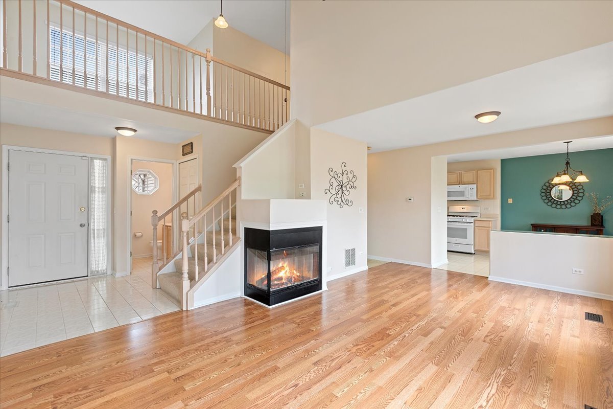 962 Willow Street Itasca, IL 60143 - Photo 9 of 33 a view of an empty room with wooden floor fireplace and a window