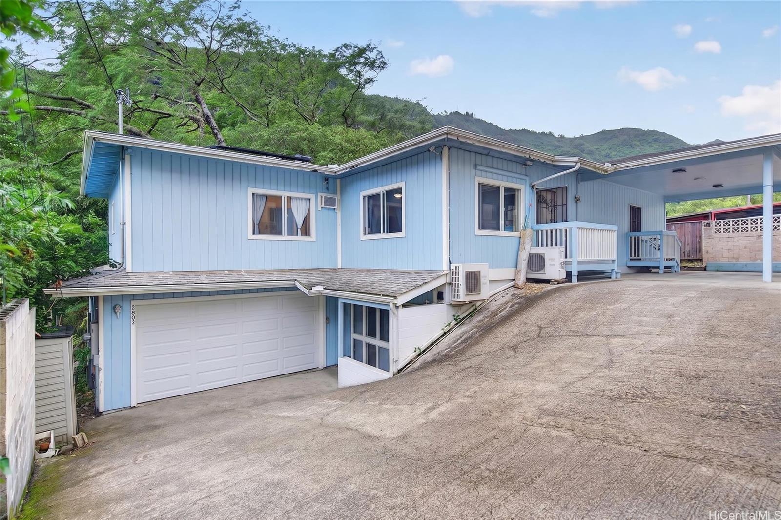 2802 Numana Road Honolulu, HI 96819 - Photo 1 of 18 a white house that has a tree in front of it