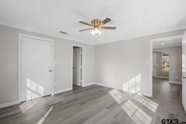 a view of empty room with wooden floor