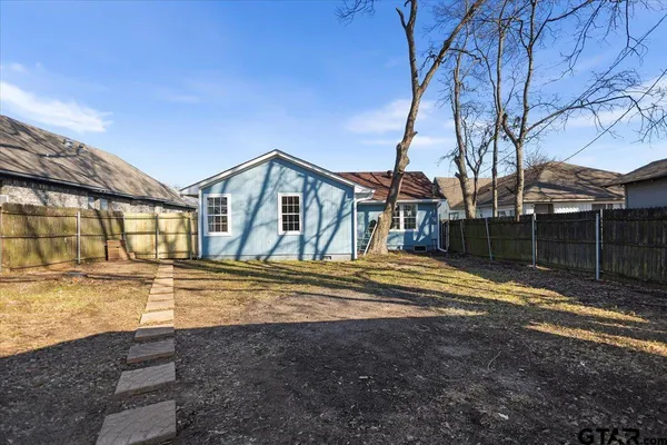 a view of a house with a yard and balcony