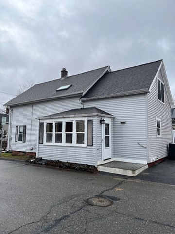 8 Grove Street Ayer, MA 01432 - Photo 20 of 20 a front view of a house with a garage