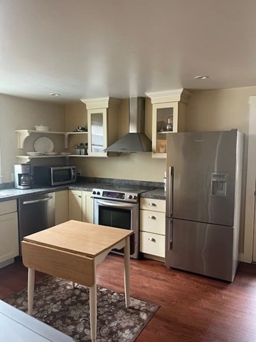 8 Grove Street Ayer, MA 01432 - Photo 3 of 20 a kitchen with stainless steel appliances granite countertop a stove a refrigerator and a stove top oven