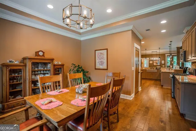 a view of a dining room with furniture and a chandelier