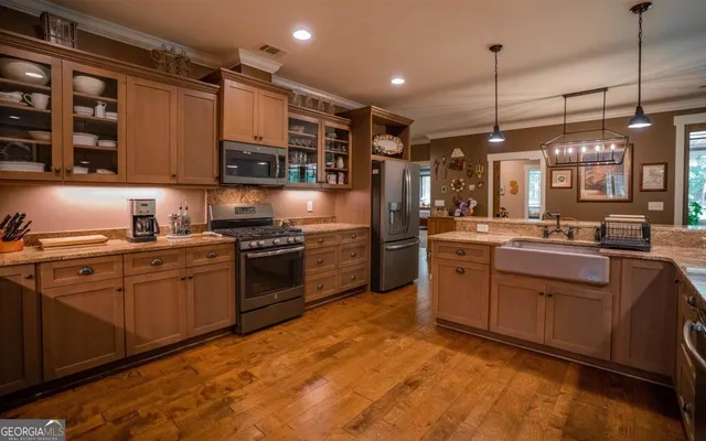 a kitchen with a sink cabinets and stainless steel appliances