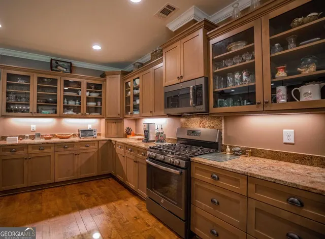 a kitchen with stainless steel appliances granite countertop a stove and a sink