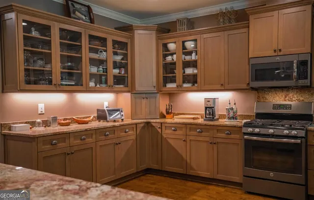 a stove top oven sitting inside of a kitchen