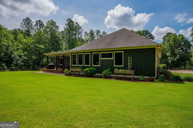 a view of house with garage and plants