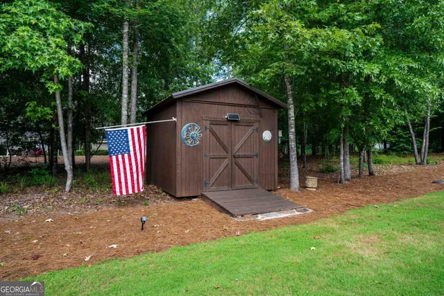 an aerial view of a house with a yard and garden
