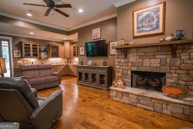 a living room with furniture a flat screen tv and a fireplace