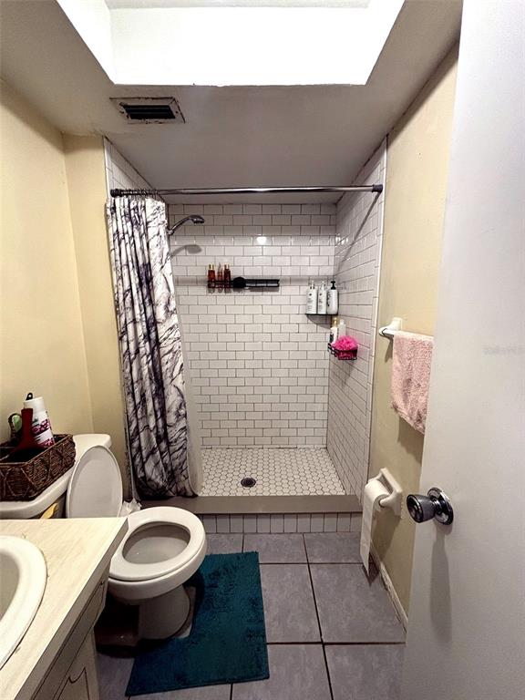 1433 South Belcher Road, Unit B2 Clearwater, FL 33764 - Photo 11 of 20 a bathroom with a sink a toilet and shower