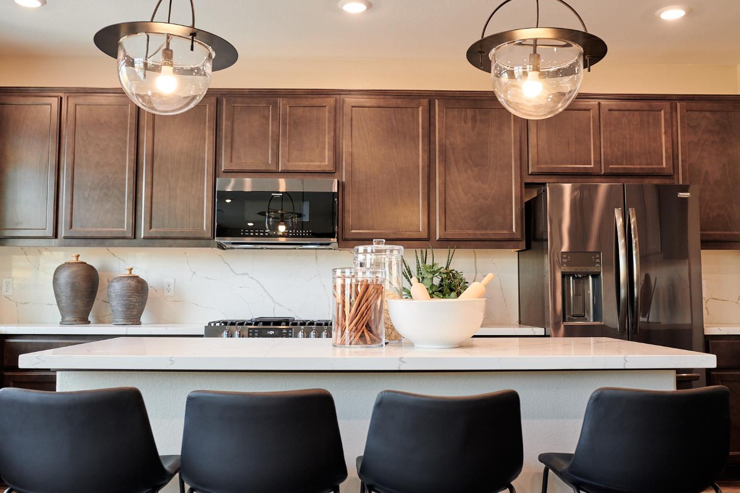 4719 Ariel Street Keyes, CA 95328 - Photo 8 of 22 a kitchen with a table chairs and microwave